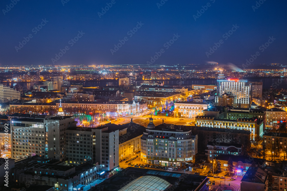 Night cityscape from rooftop to Lenin square. Houses, trade centers 