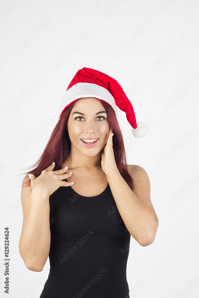 Surprised woman in christmas hat touching her cheek. Surprised woman in christmas hat touching her cheek.