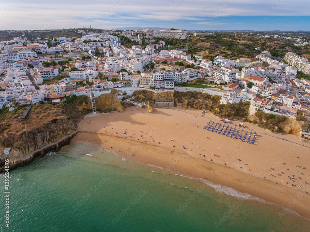 Beach fishermen, tourists on holiday in Albufeira.