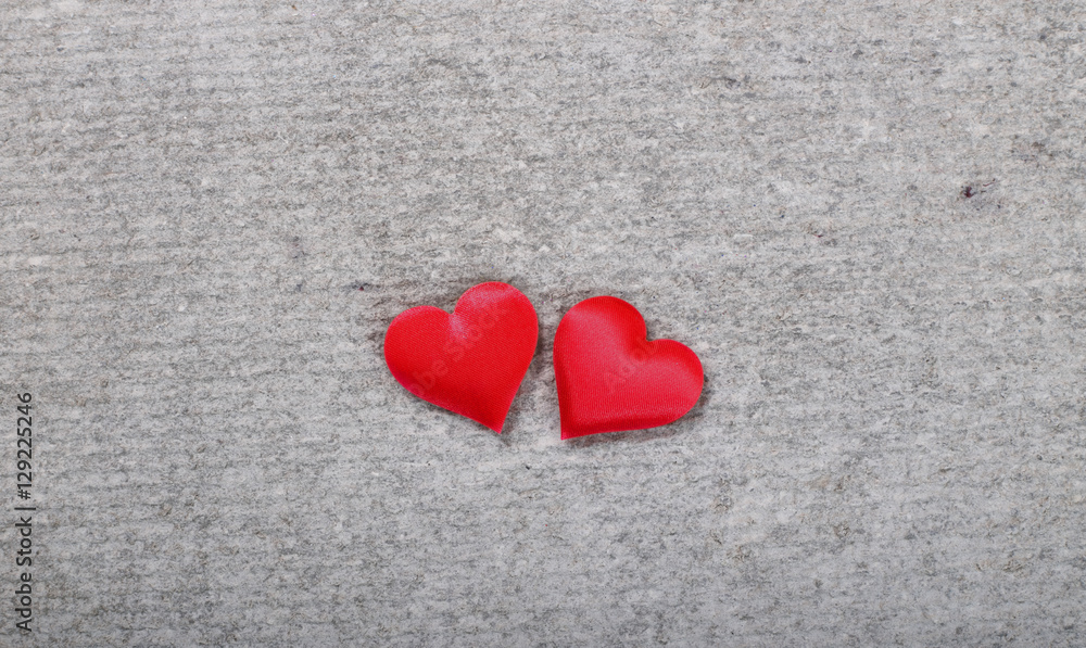 Two red hearts on a gray background
