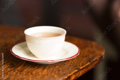 Fototapeta Naklejka Na Ścianę i Meble -  A cup of hot tea on a brown table