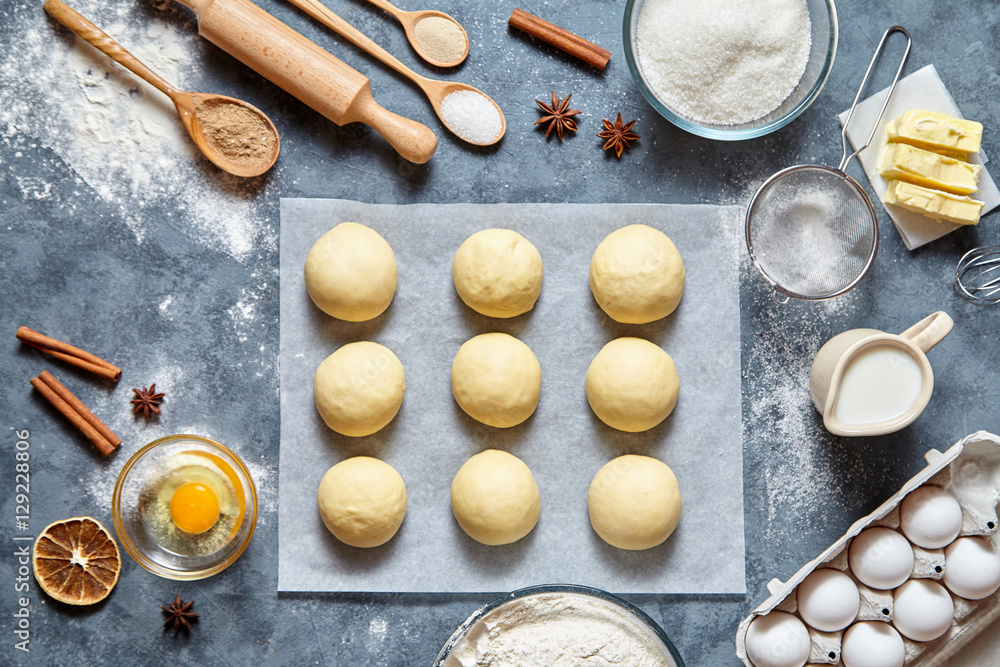 Buns dough homemade preparing recipe, ingridients food flat lay on kitchen table background. Working with butter, milk, yeast, flour, eggs, sugar pastry or bakery cooking. Buns dough homemade preparing recipe, ingridients food flat lay on kitchen table background. Working with butter, milk, yeast, flour, eggs, sugar pastry or bakery cooking.