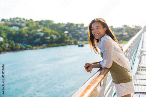 Cruise ship vacation Asian woman relaxing on deck enjoying view from boat of port of call city on St. Lucia island in the Caribbean. Happy casual tourist girl outside on tropical holiday destination.