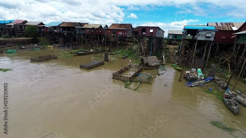 Aerial view of fishing and tour boats navigating through Kampong Khleang in Cambodia, one of the many villages along Tonle Sap lake in southeast Asia