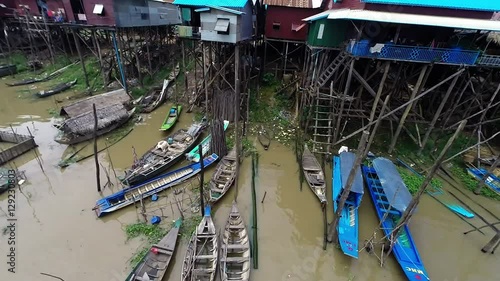 Aerial view of fishing and tour boats navigating through Kampong Khleang in Cambodia, one of the many villages along Tonle Sap lake in southeast Asia