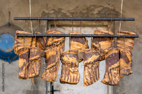 Hanging smoked domestic pork bacon photo