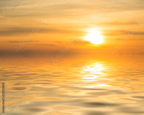 Sunset over calm ocean or sea