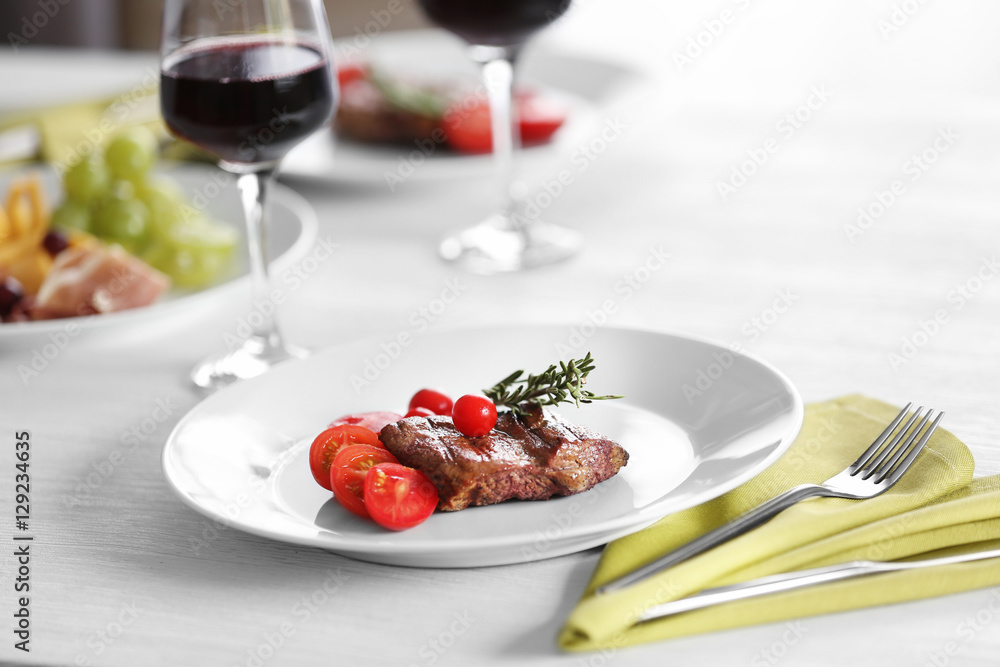 Steak and appetizers with wine on table Steak and appetizers with wine on table