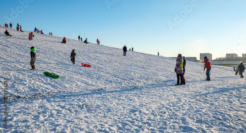 Snow sledding hill in a city photo