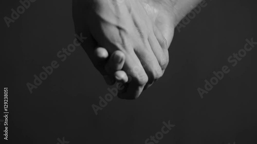 close up man and woman hand touching holding together on blurred background.