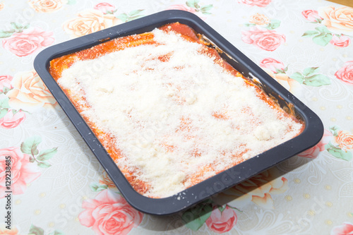 woman preparing Italian lasagna. Chef kitchen italian baked pasta. Lasagna Bolognese