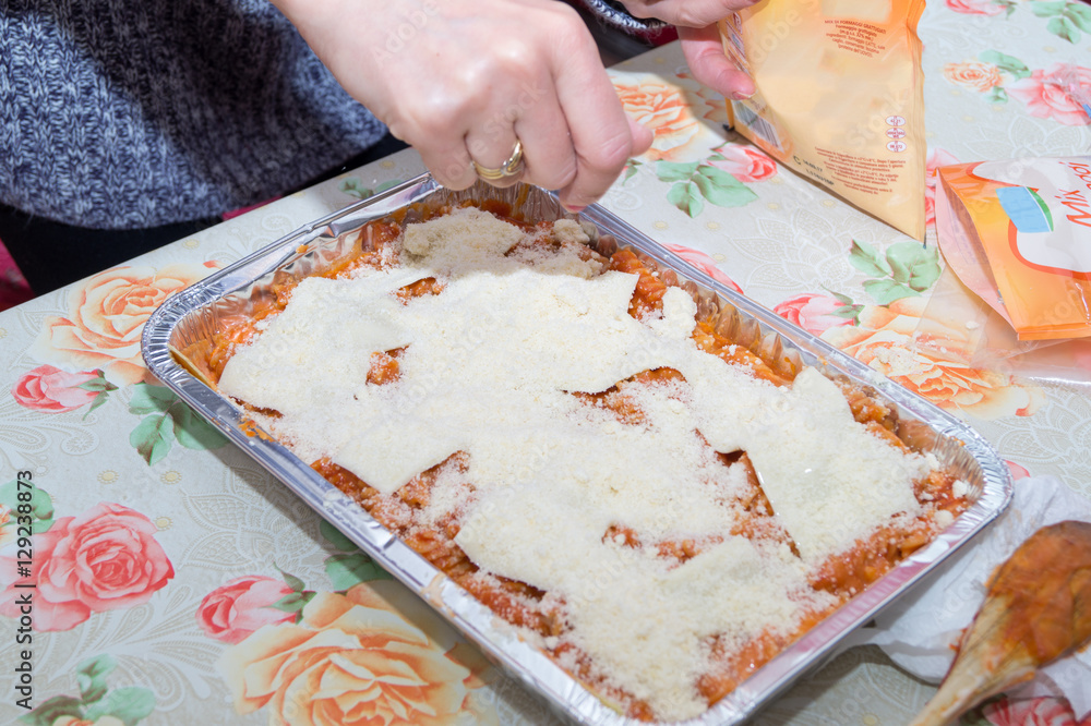 woman preparing Italian lasagna. Chef kitchen italian baked pasta. Lasagna Bolognese