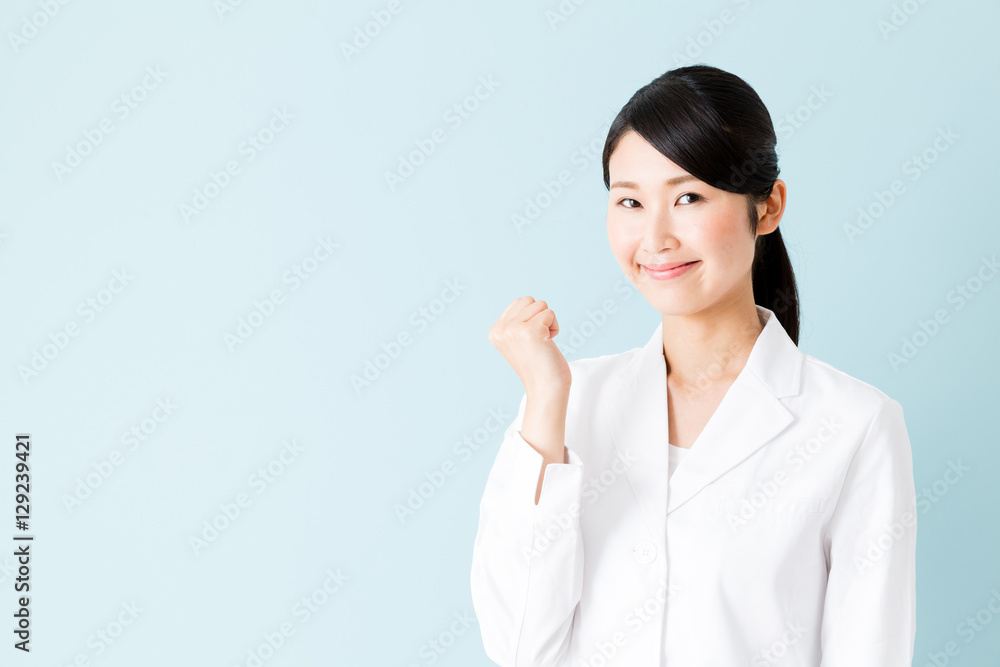 portrait of young asian nurse isolated on blue background portrait of young asian nurse isolated on blue background