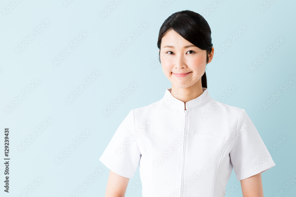 portrait of young asian nurse isolated on blue background portrait of young asian nurse isolated on blue background