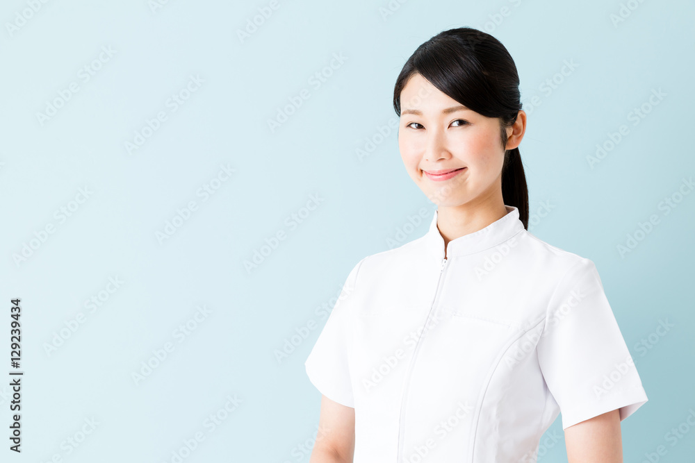 portrait of young asian nurse isolated on blue background portrait of young asian nurse isolated on blue background