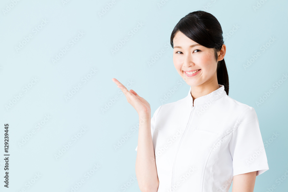 portrait of young asian nurse isolated on blue background portrait of young asian nurse isolated on blue background