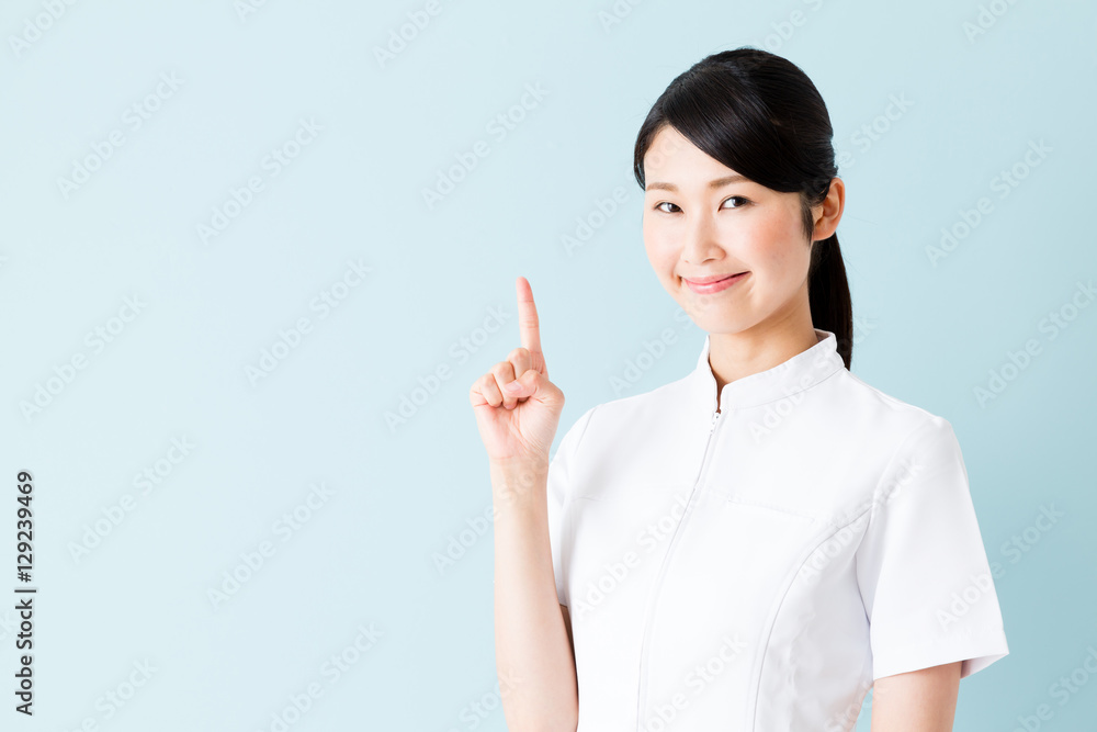 portrait of young asian nurse isolated on blue background portrait of young asian nurse isolated on blue background