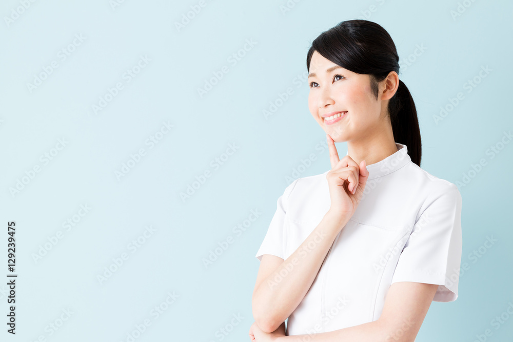 portrait of young asian nurse isolated on blue background portrait of young asian nurse isolated on blue background