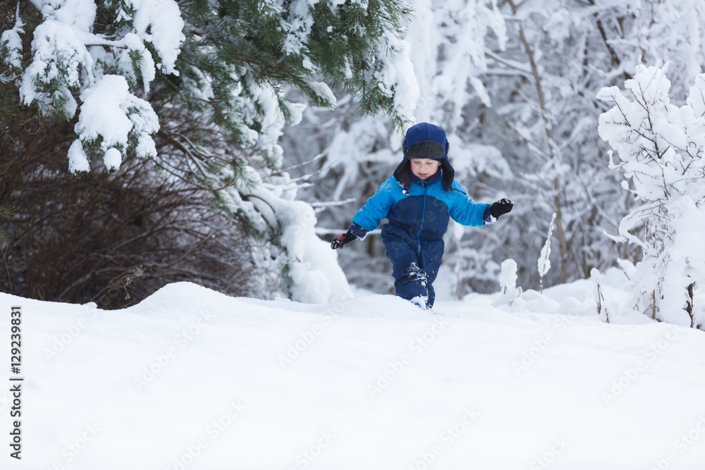 Happy caucasian child playing in snow