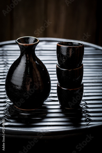 Tasty sake in black ceramics on black table