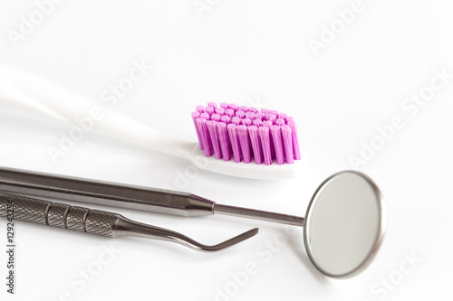 dental care toothbrush with dentist tools on white background