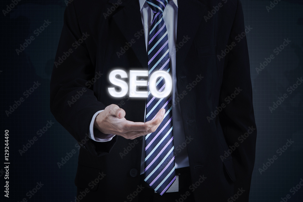 Entrepreneur hand holds SEO word Entrepreneur hand holds SEO word