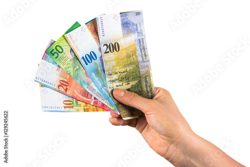 Hand holding swiss franc banknotes