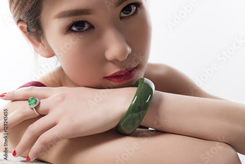 With a jade bracelet and ring young beautiful woman.