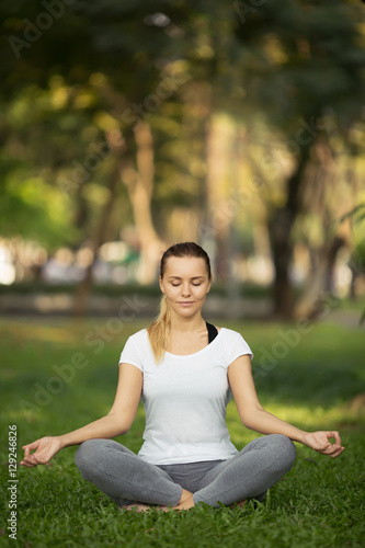 Young woman meditation in city park. Yoga exercise
