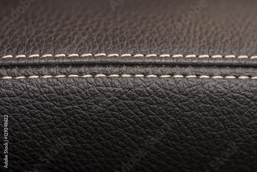 Leather background with stich. Car interior detail. Macro.