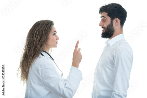 Doctor with ticking clock and Serious Male Patient
