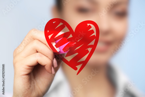Cardiologist drawing heart,...