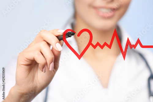 Cardiologist drawing heart,...