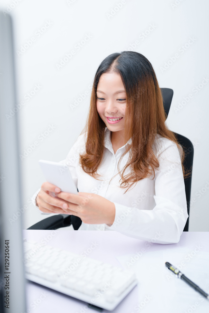 Young businesswoman using smart phone work in office. Young businesswoman using smart phone work in office.