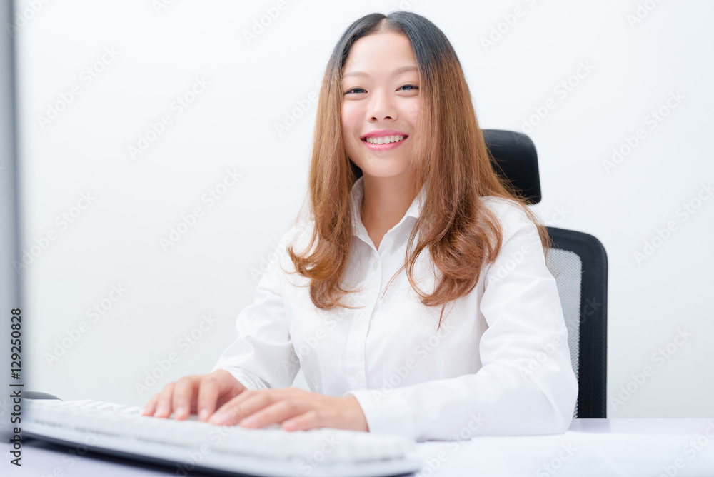 Young businesswoman working on computer. Young businesswoman working on computer.