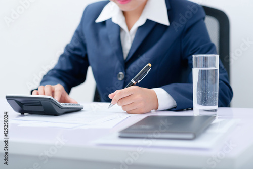 Accountant filling the form at desk.