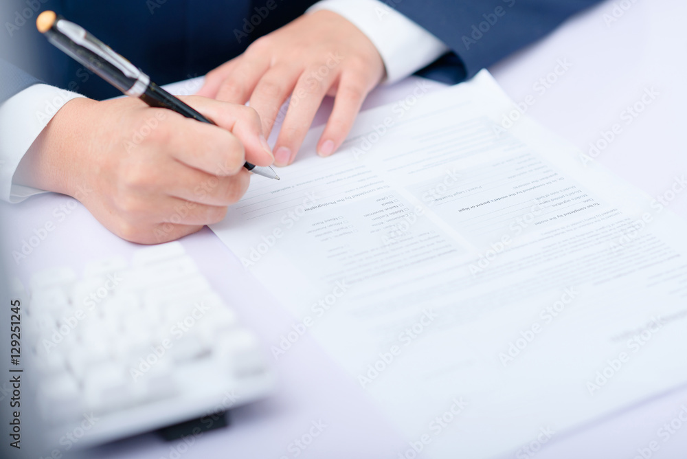 Signing on the form. Signing on the form.