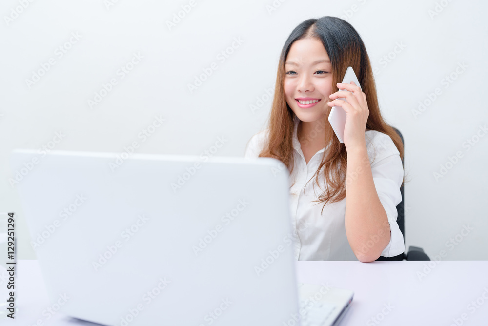 Young business woman using smart phone and laptop work. Young business woman using smart phone and laptop work.