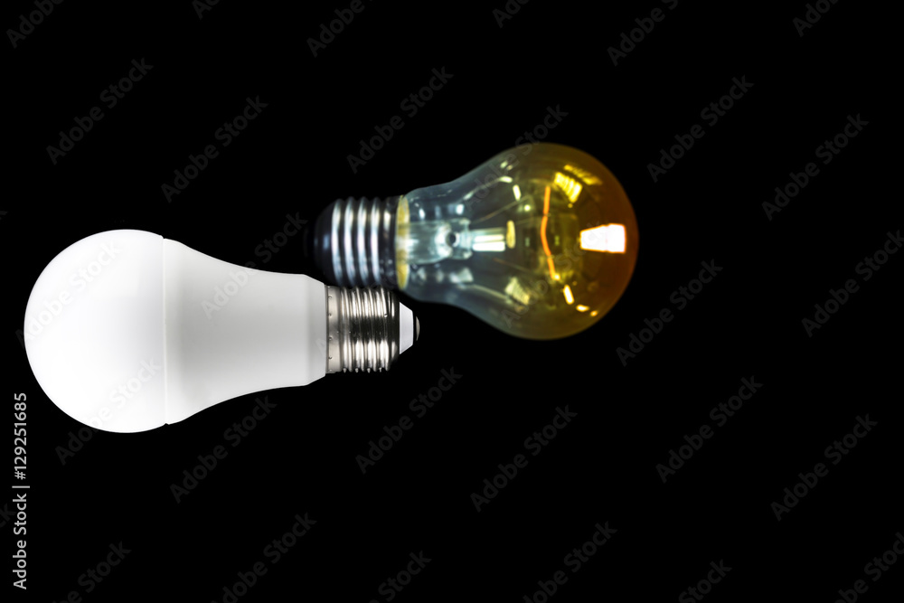 Led light bulb on dark background with Blurred incandescent light bulb and copy space on the right screen Led light bulb on dark background with Blurred incandescent light bulb and copy space on the right screen