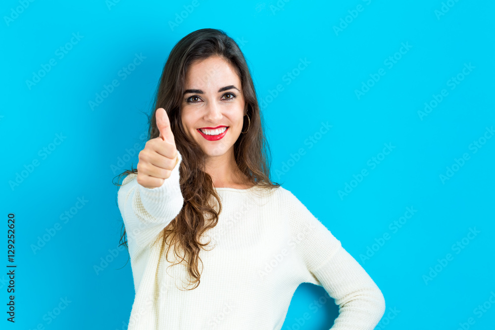 Happy young woman giving a thumb up Happy young woman giving a thumb up
