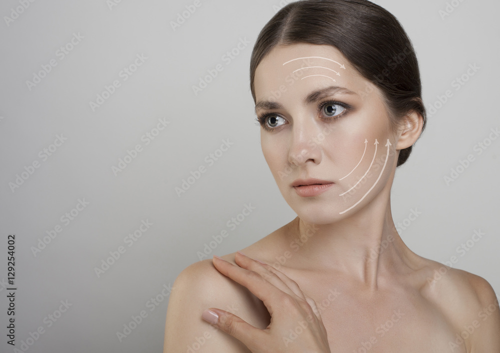 Beauty young woman with arrow in ner fgace studio shot isolated