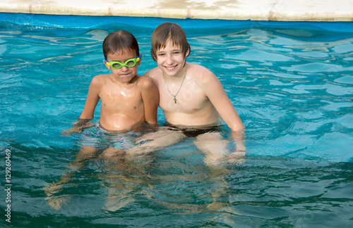 twin  boys relaxing in the pool