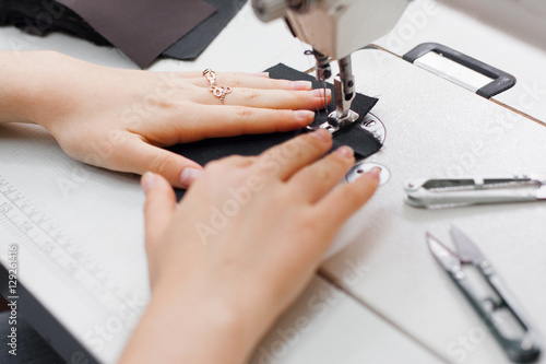 Seamstress Sewing Machine Tailor Needlework Garment Equipment Clothes Workshop Concept © golubovy