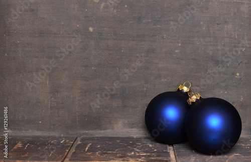 Blue & gold Christmas ornaments border on wooden background