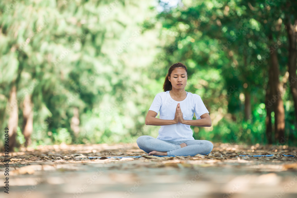 Young asian woman doing yoga in the morning at the park. Healthy Young asian woman doing yoga in the morning at the park. Healthy