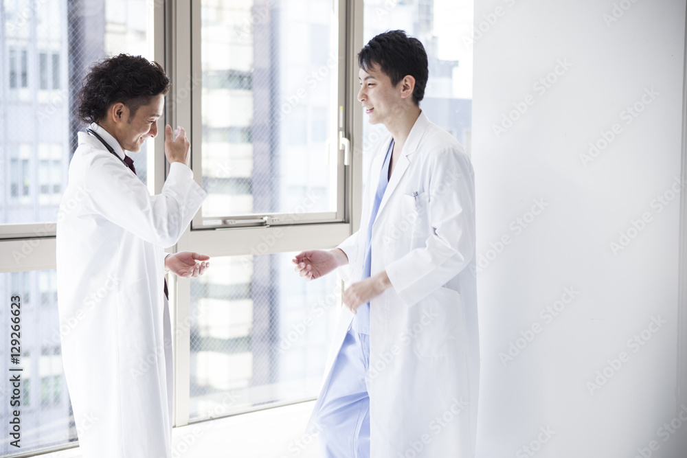 Male doctors are talking in the hall of the hospital Male doctors are talking in the hall of the hospital