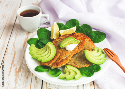 Potato fritters  with sliced avocado, spinach and lime.
