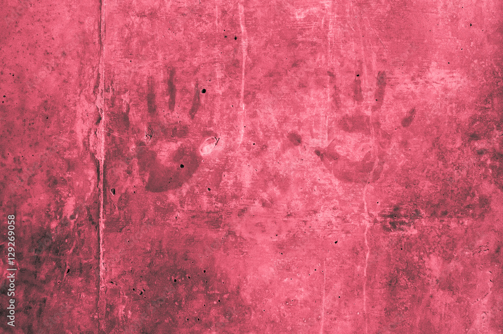 childrens hand impressions on a red reddish gray wall with scratches 