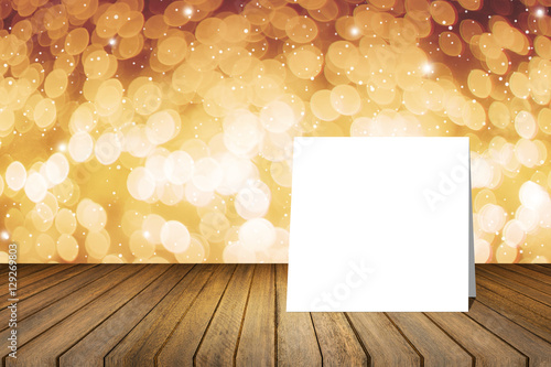 White card put on wooden desk against blurred abstract out of focus bokeh light background.use for present or mock up your product.product display template.Business presentation.clipping path include