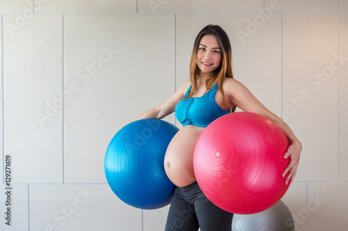 Portrait of asian Pregnant female do exercise in sports room, ho